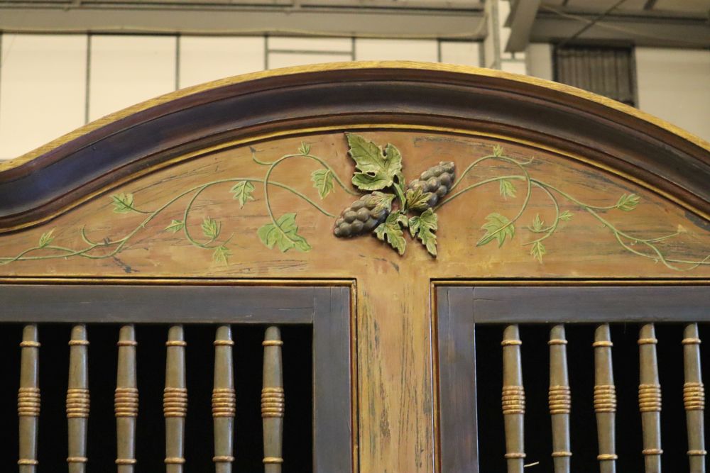 A 19th century Continental painted armoire, later decorated with birds on branches, rabbits and fish, the top two doors each enclosing